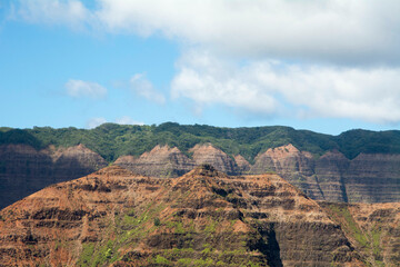 High view of Waimea Canyon with blue sky and clouds in Kauai, Hawaii