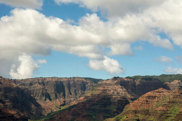 High view of Waimea Canyon with blue sky and clouds in Kauai, Hawaii