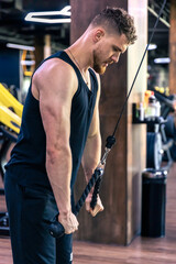 Ahlete doing push-ups in the gym with a bare torso. Sport lifestyle.