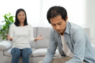 Family divorce problem concept, Husband and wife sitting separating after arguing in the living room at home.
