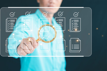A manager conducting a quality assessment of a business document using a checklist.