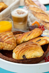 Traditional French style breakfast with Viennoiseries, Cappuccino coffee and orange juice