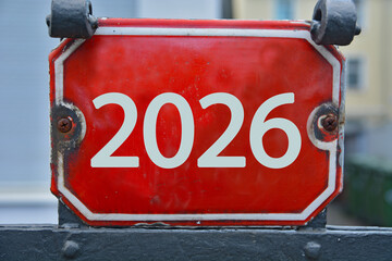 A red colored house number plaque, showing the number 2026 (number two thousand twenty six) 