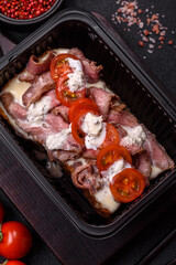 Sandwich with brioche bun, roast beef, tomatoes, stracciatello