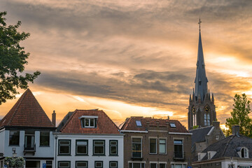 Fototapeta premium Skyline of Weesp, North Holland, The Netherlands. View of the St. Laurentius church and historical houses by sunset