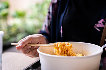 Chopstick holding some noodle