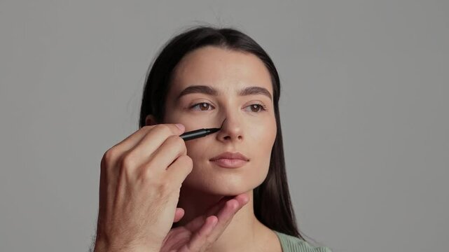 Preparing for Rhinoplasty nose surgery 4k video. Plastic surgeon is marking rhinoplasty procedure plan on external nose and its surrounding structure. Accurate changing of nose size and proportion.