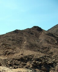 Mountains in Sinai, Egypt, Showcase Rugged Terrain Under a Clear Blue Sky During Daylight Hours