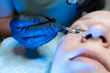 Beauty Close-up of a woman having her eyelashes enhanced with an lash lift and mascara by a...