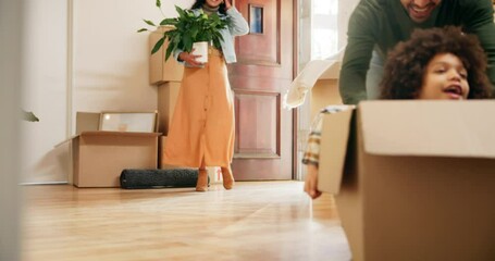 Family, child and playing in box in new house for investment opportunity and celebration of property relocation. Homeowner, people and excited in front door of dream home for real estate achievement