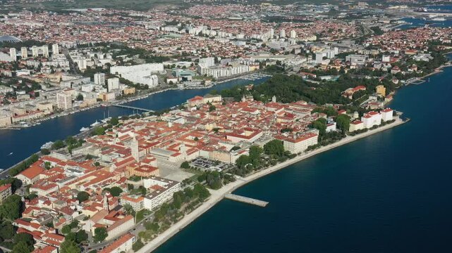 Aerial shot of Zadar old town, famous tourist attraction in Croatia. Waterfront aerial summer view, Dalmatia region of Croatia. Drone, 4k.