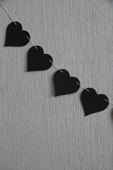 Black paper hearts garland is romantic decoration for Saint Valentine day.