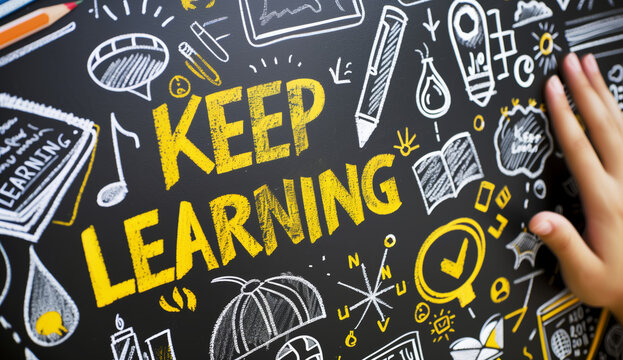 Keep learning written on chalkboard. Concept of knowledge, improvement, development and keeping up the motivation to learn new things in study, school and career.
