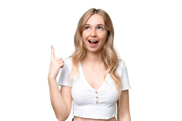 Young English woman over isolated background pointing up and surprised