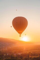 Naklejka premium Hot air balloon flying high in the sky at sunset.