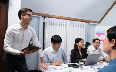 Analyst team utilizing BI Fintech to analyze financial data at table in meeting room. Businesspeople analyzing BI dashboard power on paper for business insight and strategic marketing planning.Prudent