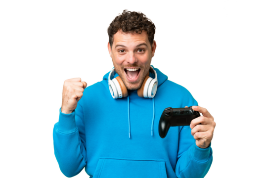 Brazilian man playing with a video game controller over isolated chroma key background celebrating a victory in winner position