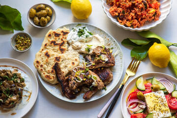 Greek food, lamb chops with couscous, feta salad, hummus and flat breads © Magdalena Bujak