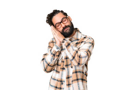 Young man with beard over isolated chroma key background making sleep gesture in dorable expression
