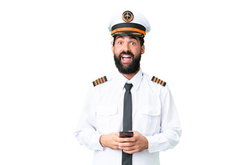 Airplane caucasian pilot man over isolated chroma key background surprised and sending a message