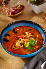 Spicy Tom Yum Seafood Soup Authentic Thai Cuisine in Vibrant Blue Bowl