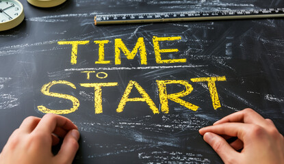 A person is writing the word "time" on a chalkboard