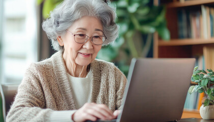 Senior woman using laptop at home for online shopping