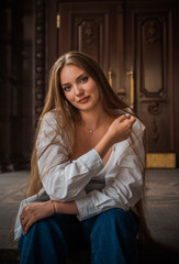 Youth concept. Nice beautiful Slavic beauty with long blonde hair, girl at city street, outdoor portrait