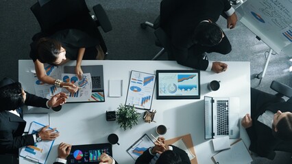 Top view of smart manager project writing at chart while looking at data. Project manager explain...