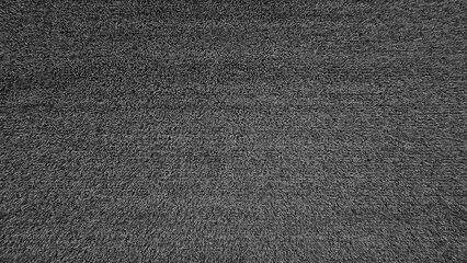 Dark gray or grey grass field for background in black and white syle. Lawn, Land, Surface, Natural wallpaper in momochrome tone.