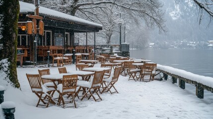 Cafe tables and chairs covered with snow, located in the German Alps near Lake Schliersee
