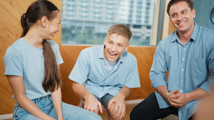 Attractive boy sharing experience during attend in group therapy. Highschool student talking about way to recovery stress while surrounded with multicultural friend listeing carefully. Edification.