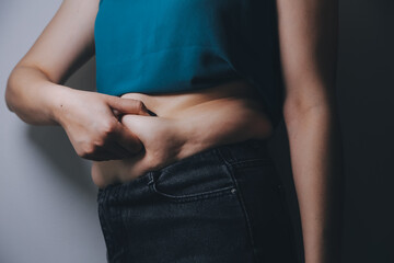 fat woman, fat belly, chubby, obese woman hand holding excessive belly fat with measure tape, woman diet lifestyle concept