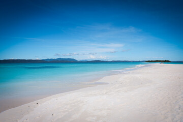 Relaxing stroll along the pristine Paradise Beach in Nosy Be with clear blue waters and soft white sand under a sunny sky