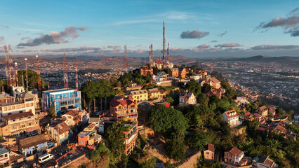 Fototapeta premium Aerial view of Antananarivo at sunset highlighting its colorful buildings and lush hillsides