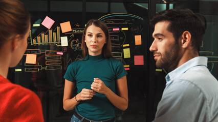 Skilled executive manager explain business idea to diverse investor team. Businesspeople listening...