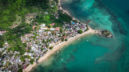 Aerial view of Nosy Komba Island, Madagascar showcasing vibrant village life and stunning turquoise...