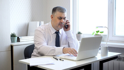 Man in Office Angry While Talking on Phone