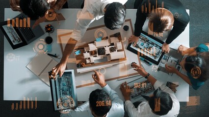 Top view of engineer architect team looking at model and talking about financial chart or investment statistic holographic. Aerial view of project manager applause to successful plan. Alimentation.