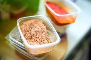 mix of spices and salt is elegantly displayed in a clear plastic container, showcasing nature's rich colors and aromas, inviting culinary inspiration and creativity
