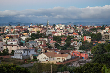 Exploring the vibrant architecture of authentic houses in Antananarivo, Madagascar, showcasing urban life against a stunning mountainous backdrop