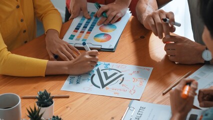 Obraz premium Top aerial view of business people working together to choosing color from color palette. Manager present idea by using tablet to marketing team while business man looking at logo graphic. Symposium.