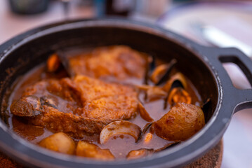 Fish from the oven with vegetables and venus clams