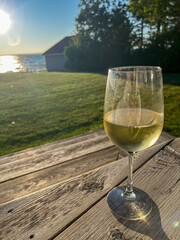 glass of wine on deck with view of lake