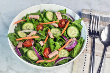 garden salad top with sliced spam,