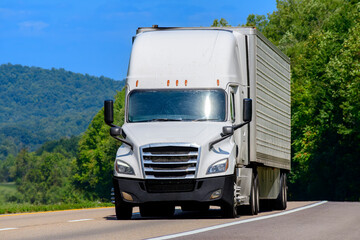 White Eighteen-Wheeler On Interstate Highway With Copy Space