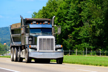 Black Heavy-Weight Dump Truck Traveling On Tennessee Interstate