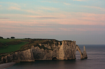 Etretat cliff under a sunset sky 