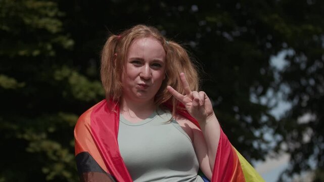 Happy member of the LGBTQ community gives a peace sign
