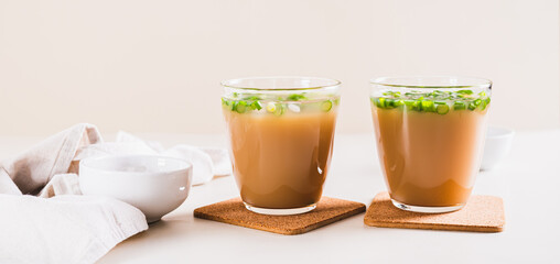 Spring iced scallion latte in glasses on the table web banner